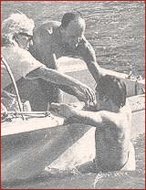 5: On the Boat #1: During the Beatles visit to Miami in February 1964, the Lads from Liverpool got to enjoy the beautiful sunny weather and the many water sports that are available in the area. Here, John Lennon climbs into the boat after having tried his hand at water skiing, as his wife, Cynthia, offers her support.